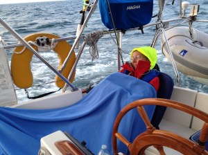 Ems napping in the cockpit. The bright yellow thing on my head is the glow in the dark hood from my foul weather jacket. 