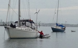 Frank making a neighborly trash pick up by dinghy