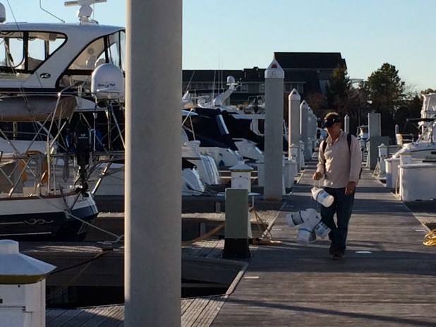 Leaving Eleanor Q in a temporary slip before she gets hauled to her land based parking spot. Frank dragging a multitude of empty gallon antifreeze jugs to the dumpster. We've done as much as we can for the day.